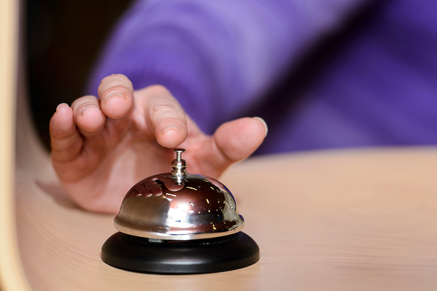 Person ringing a bell to start